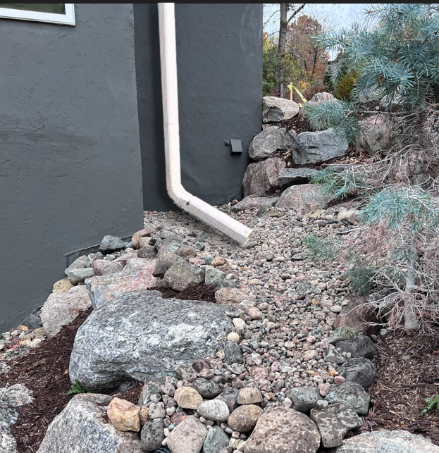 A drainpipe is hanging off the side of a building