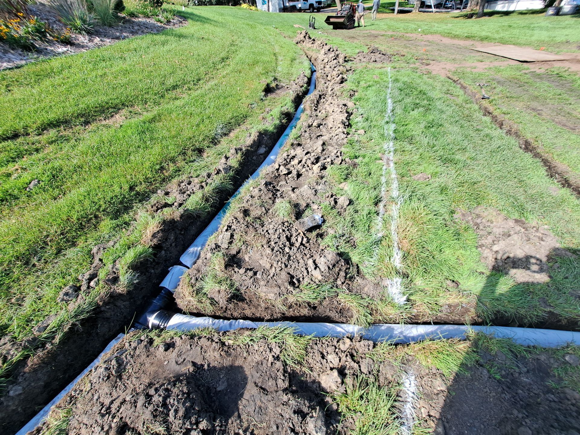 KG crew installing drain tile in a lawn in Minnetonka MN 