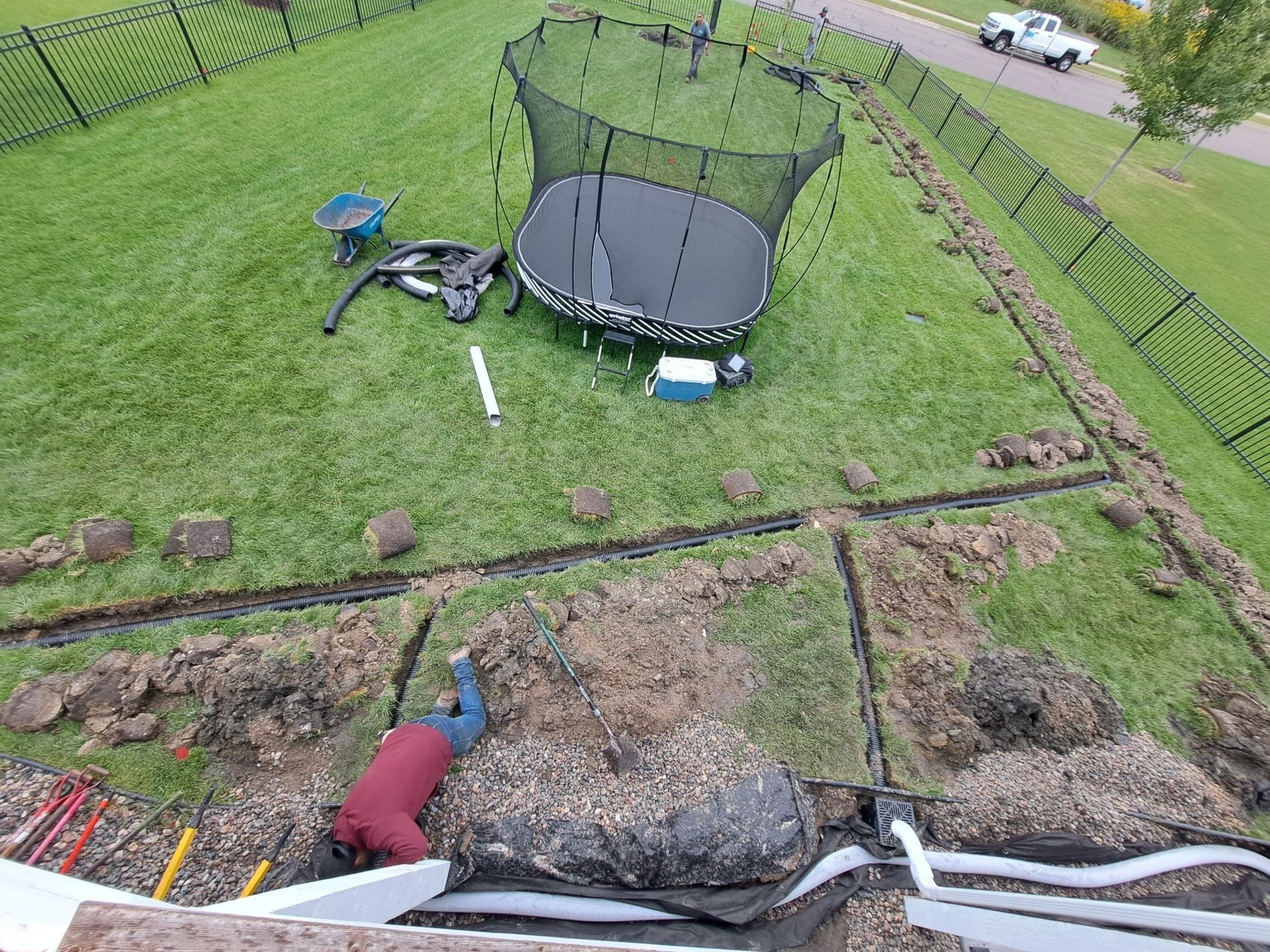 During: overhead view of our crew installing a network of underground drainage pipe in Plymouth