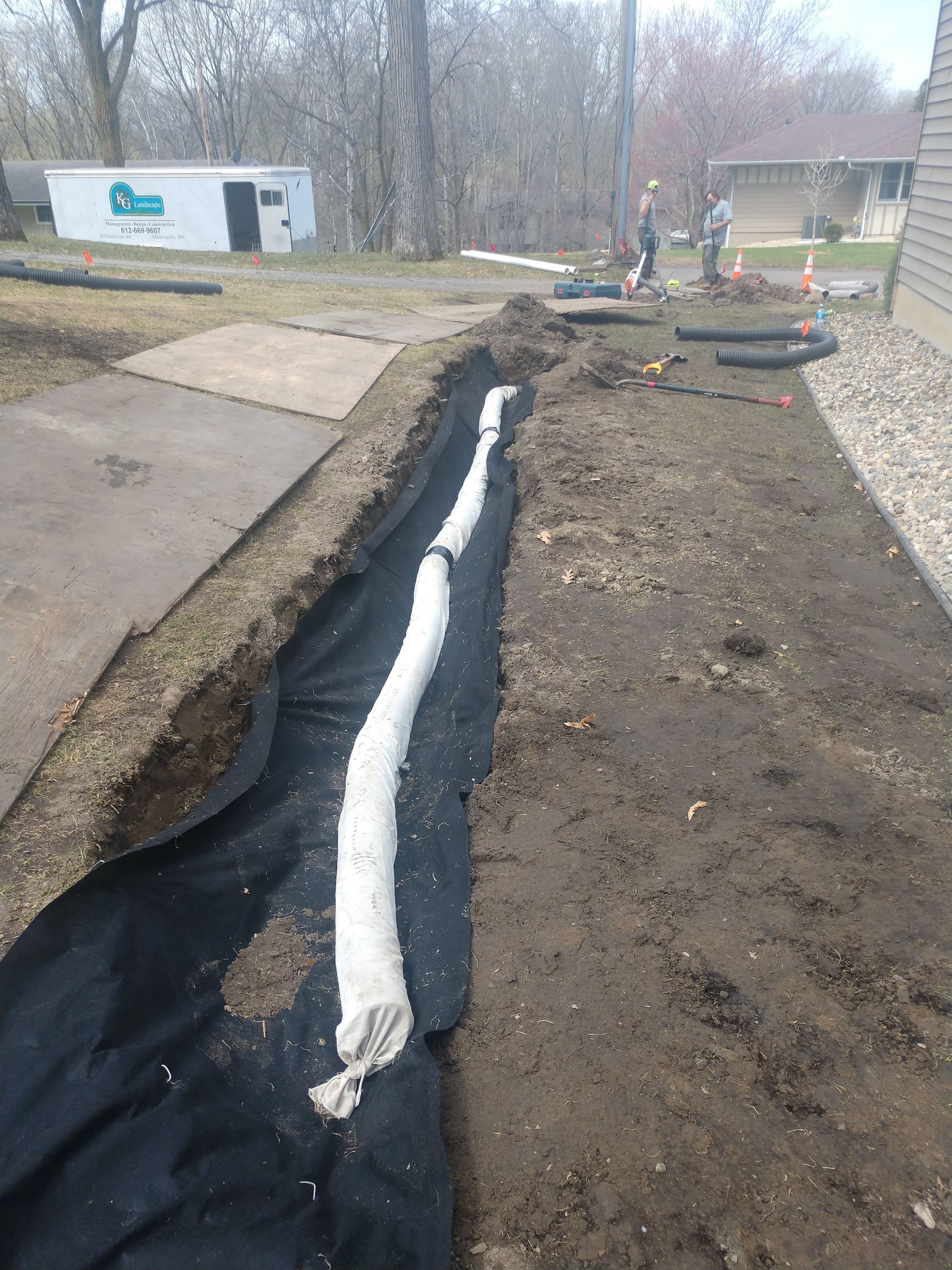 Our crew installing a French drain along the side yard