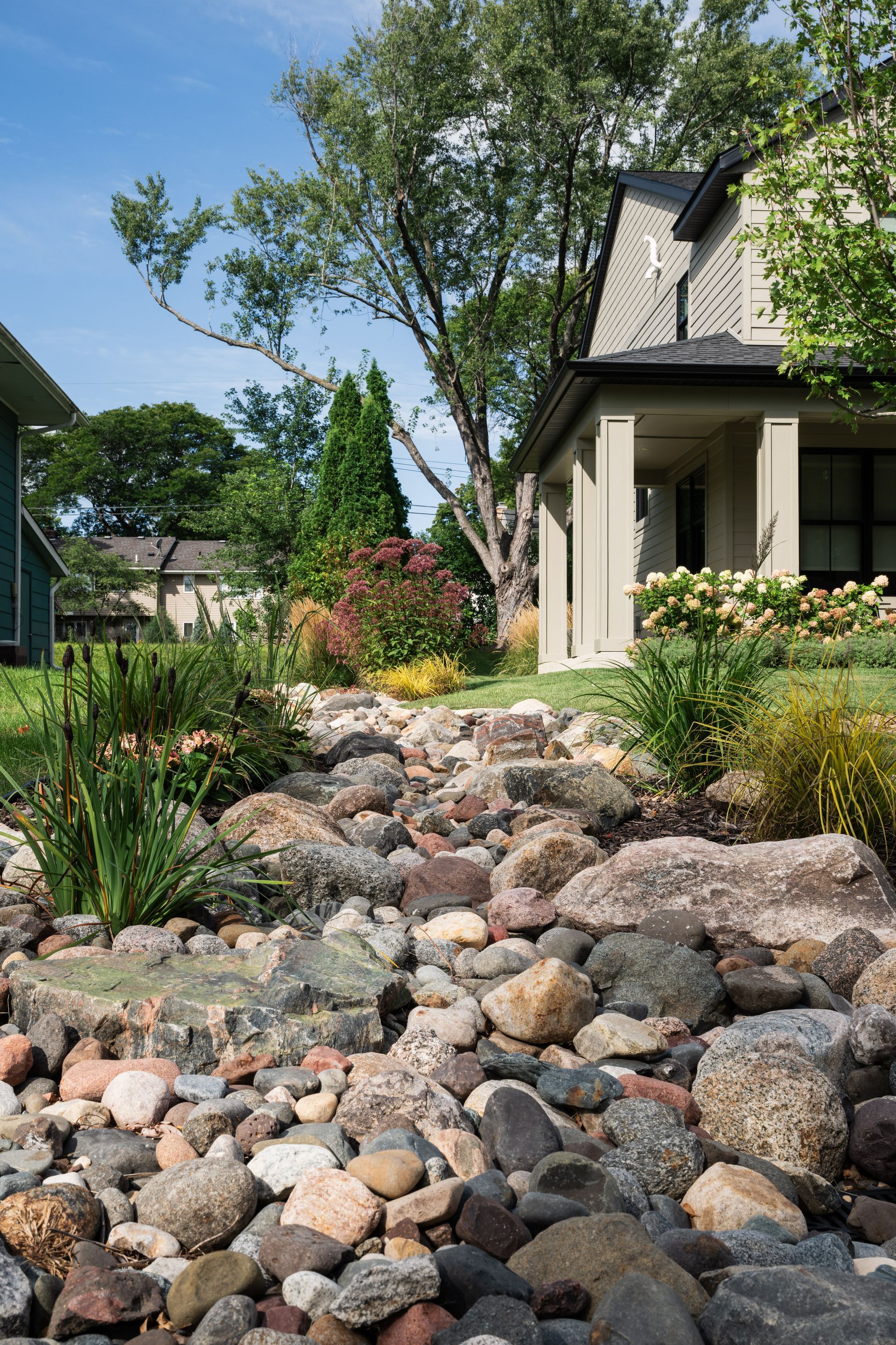 Perfect river rock and boulder dry creek bed in Edina MN designed by KG Landscape