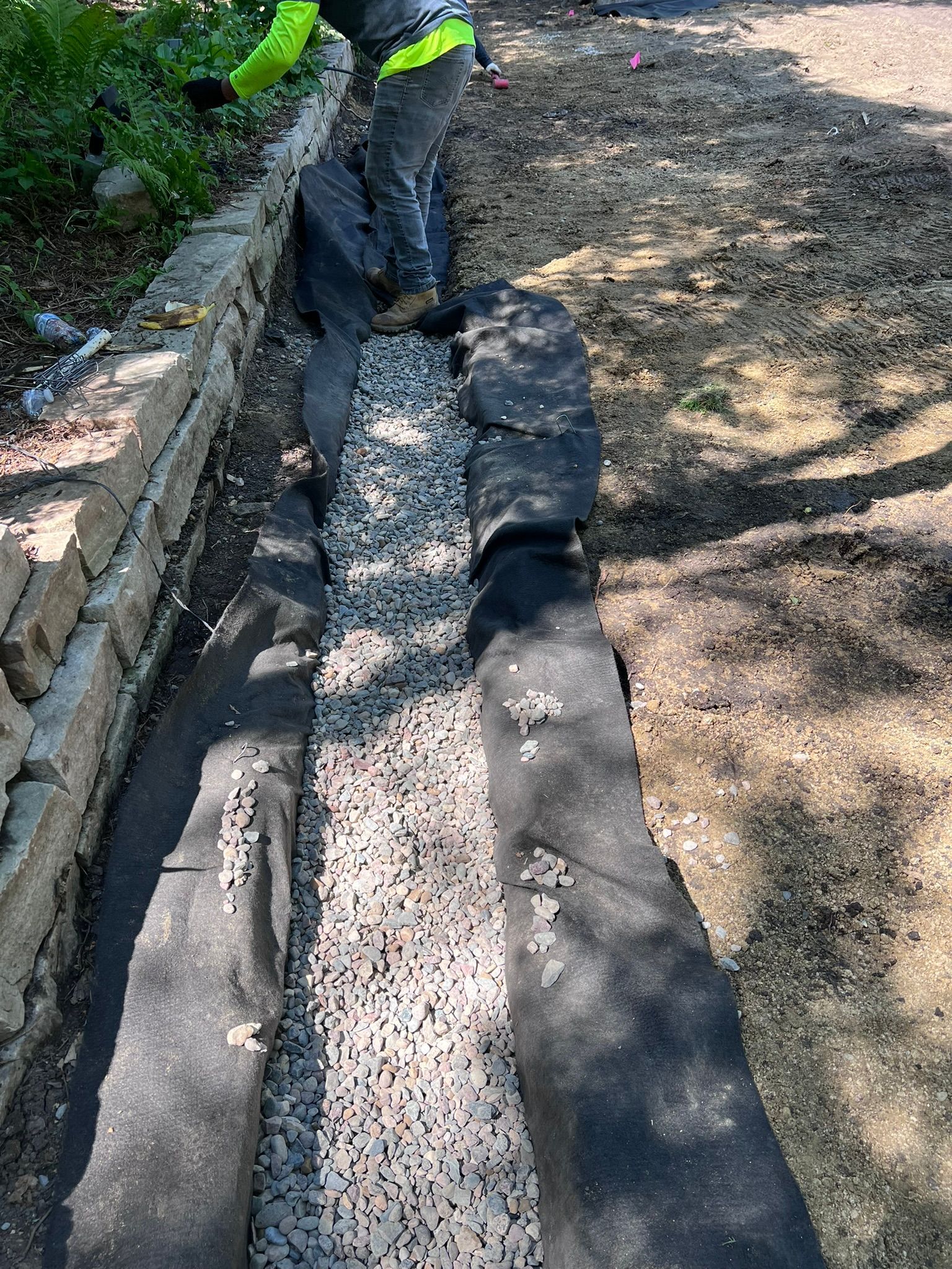French drain being installed in a backyard 
