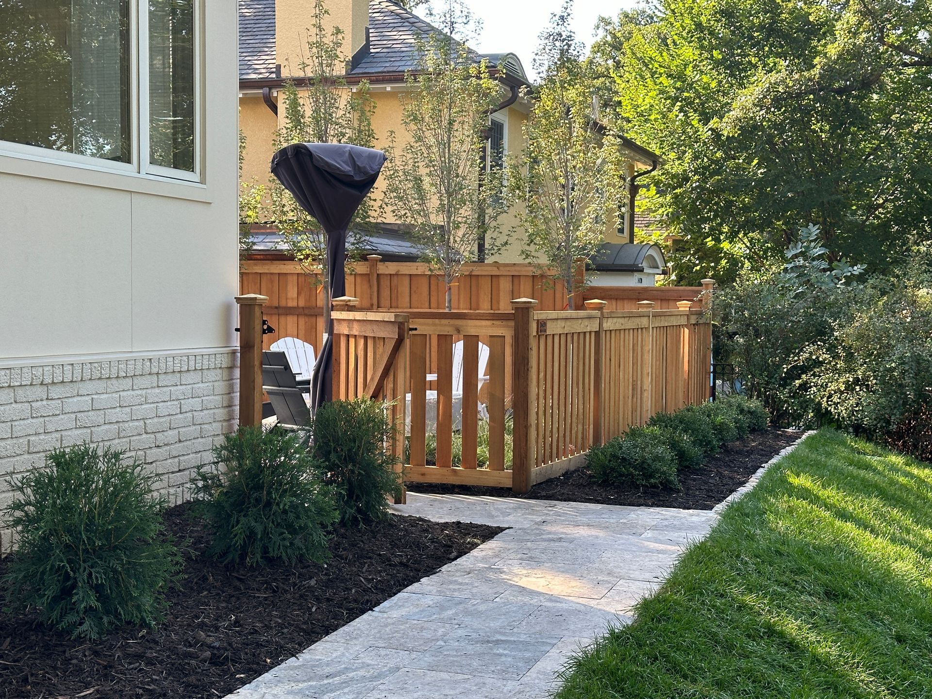 Front+Yard+walkway+to+backyard+landscaping+ideas+patio+with+natural+stone+cedar+fenced+backyard+in+Minneapolis+MN+KG+Landscape