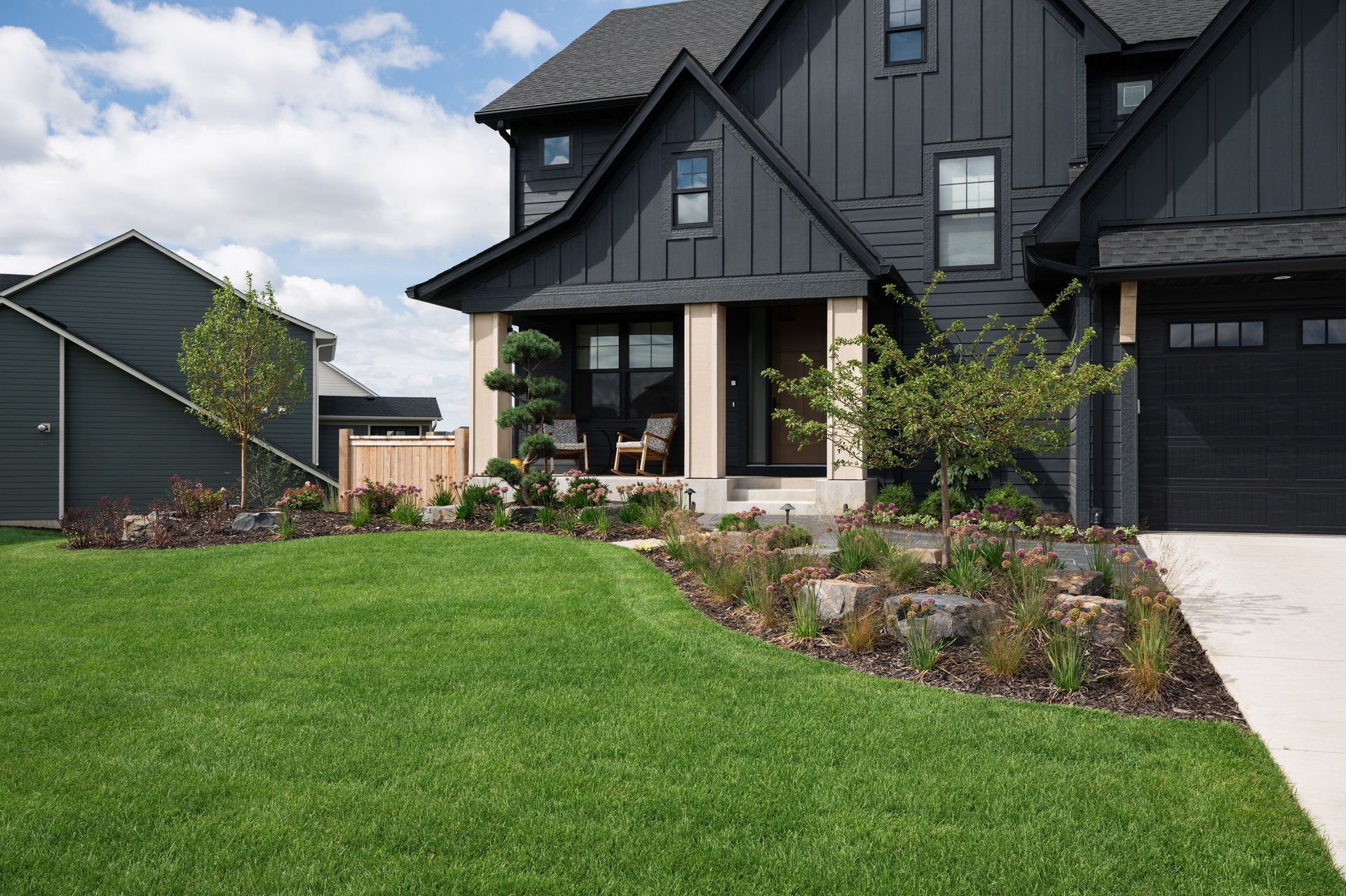 New build front lawn curb appeal with landscaping and green grass. 