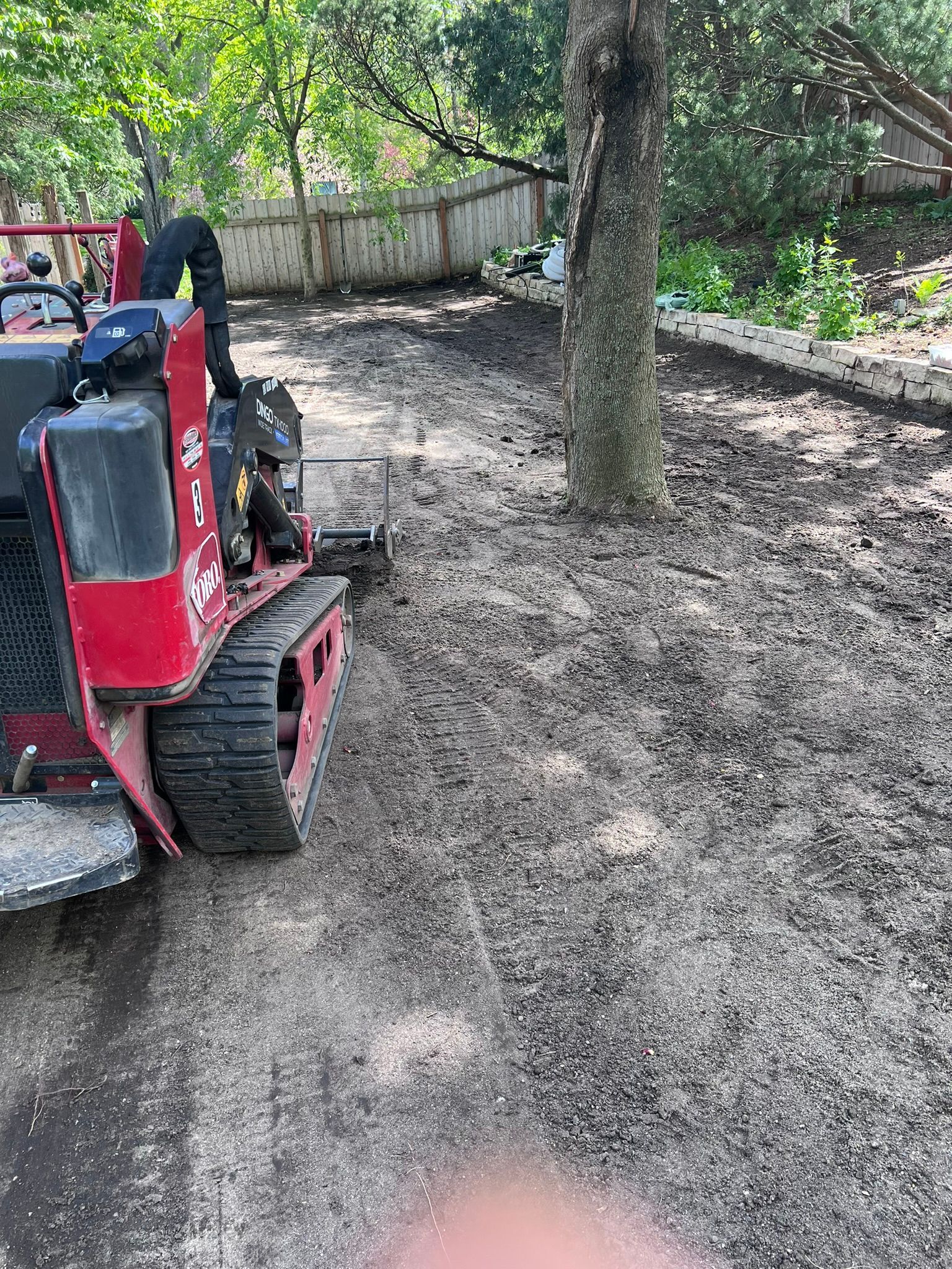 Graded+backyard+swale+using+toro+dingo+grading+bar+Edina+MN+KG+Landscape