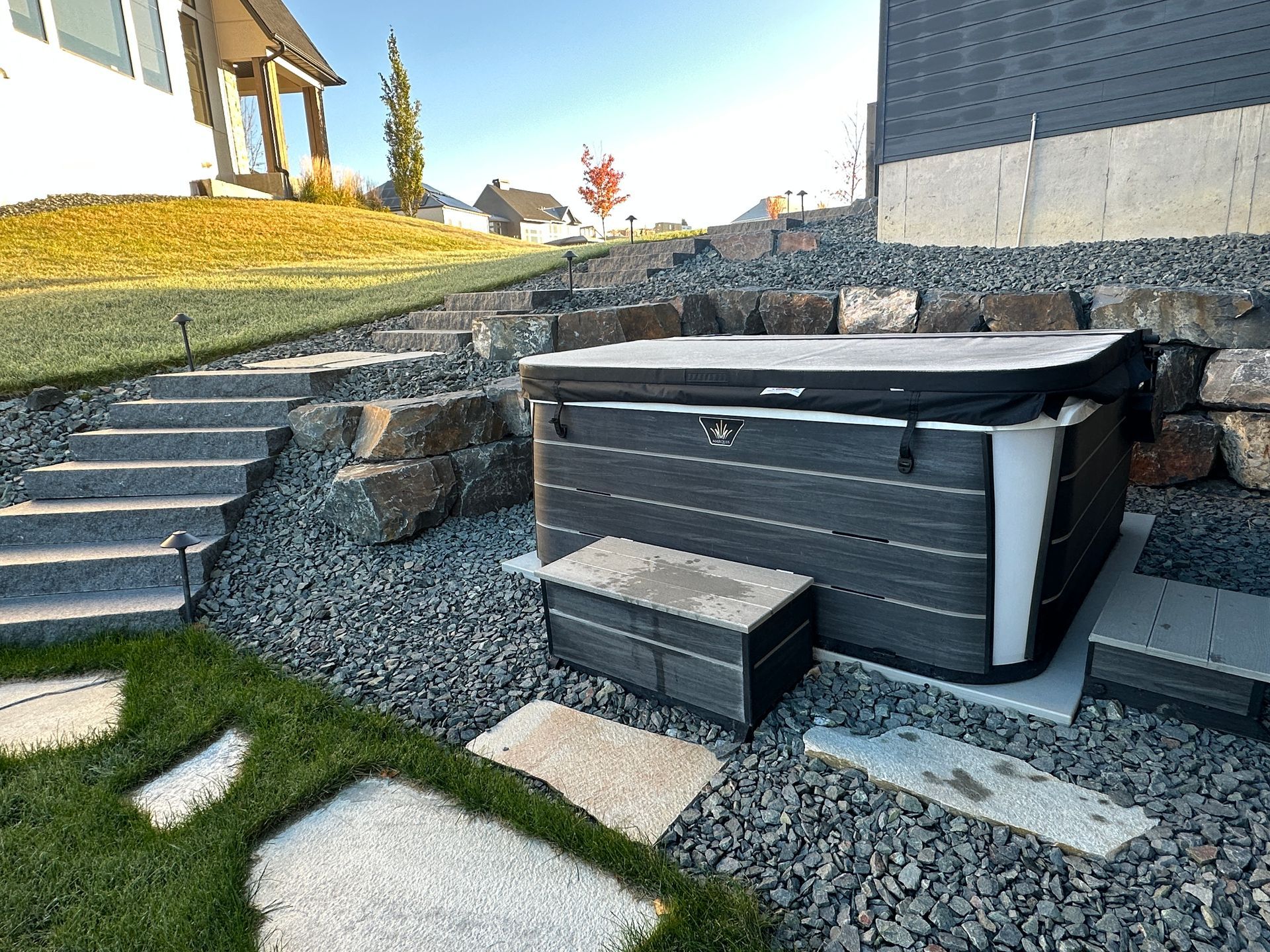 Hot tub area carved into hill with stone steps perfect design.