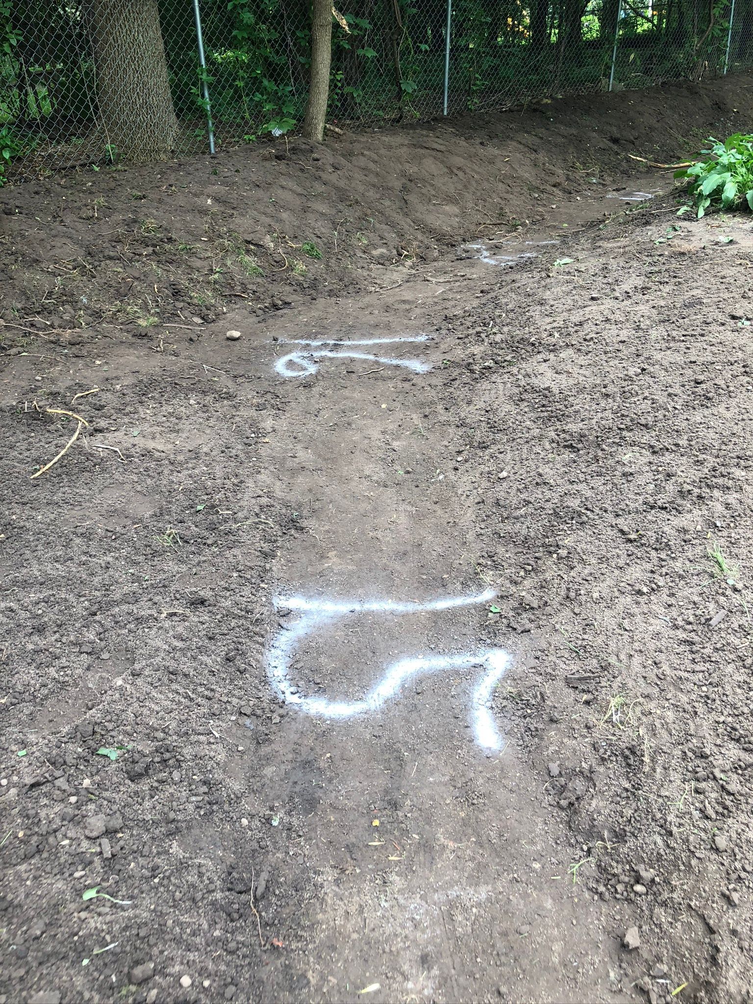 Swale graded soil outdoor drainage Minneapolis with elevations marked