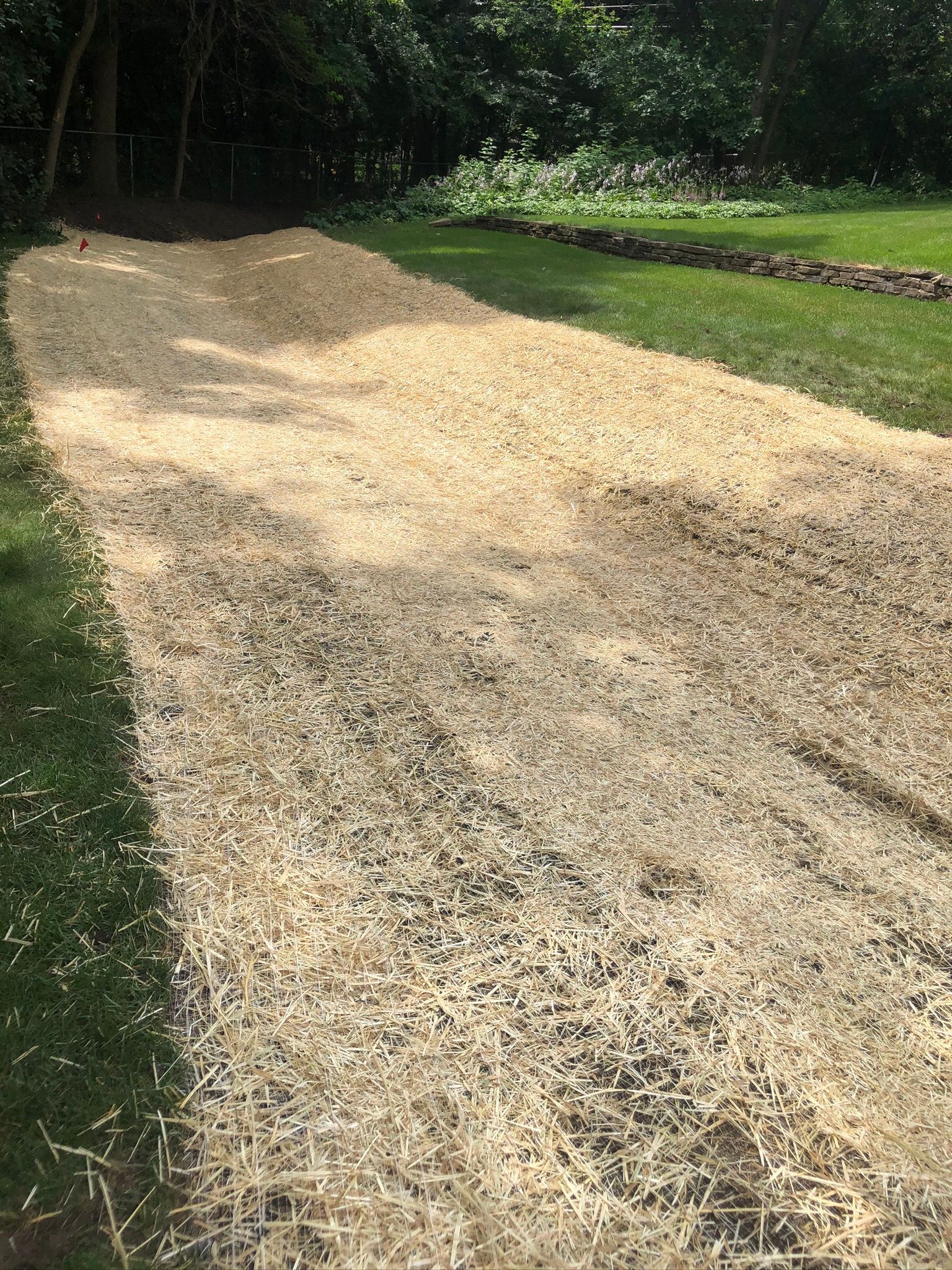 Swale grading outdoor drainage Minneapolis with straw matting 