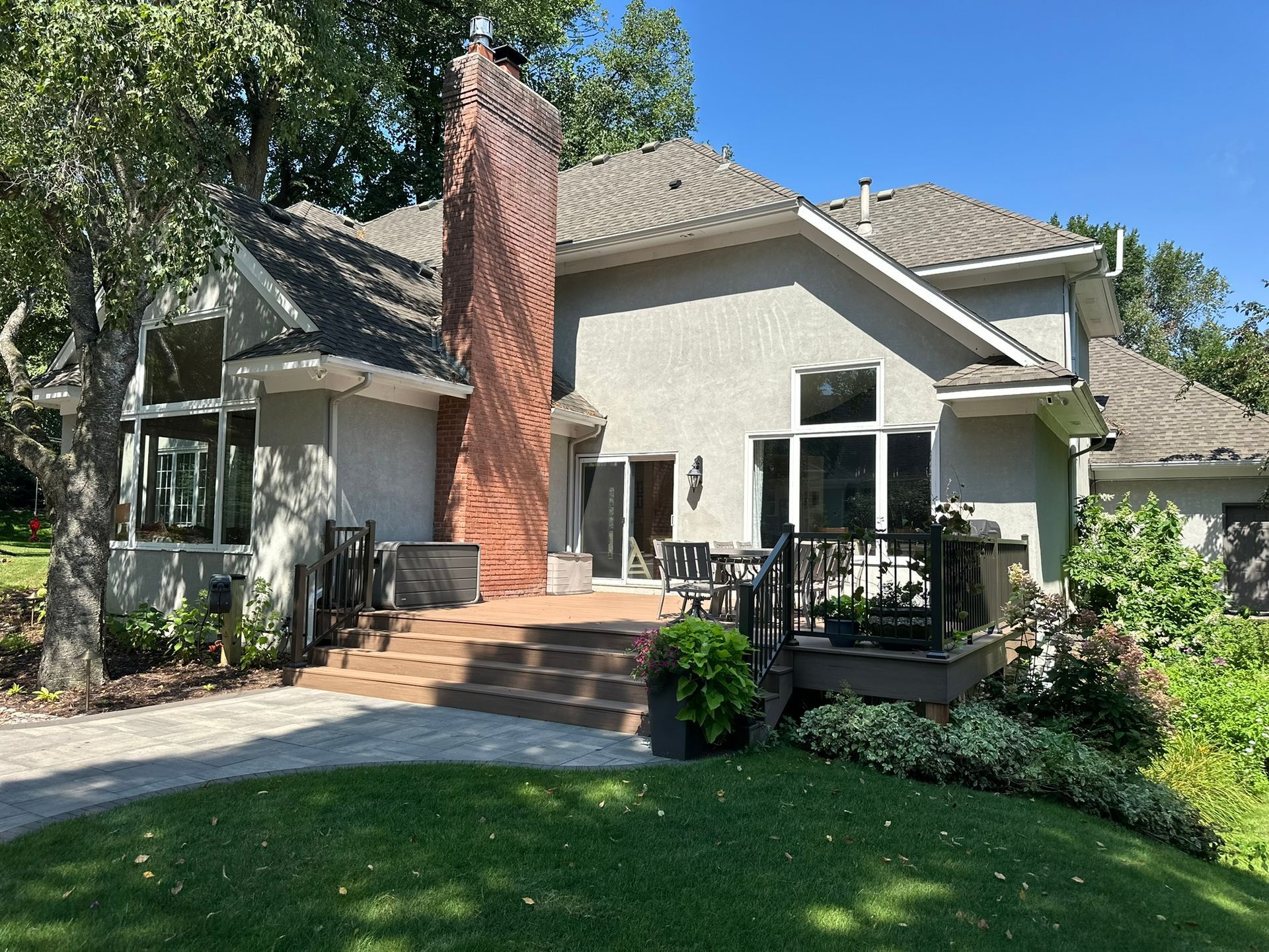 New maintenance free deck with steps we built leading down to a new paver patio in Minnetonka MN 