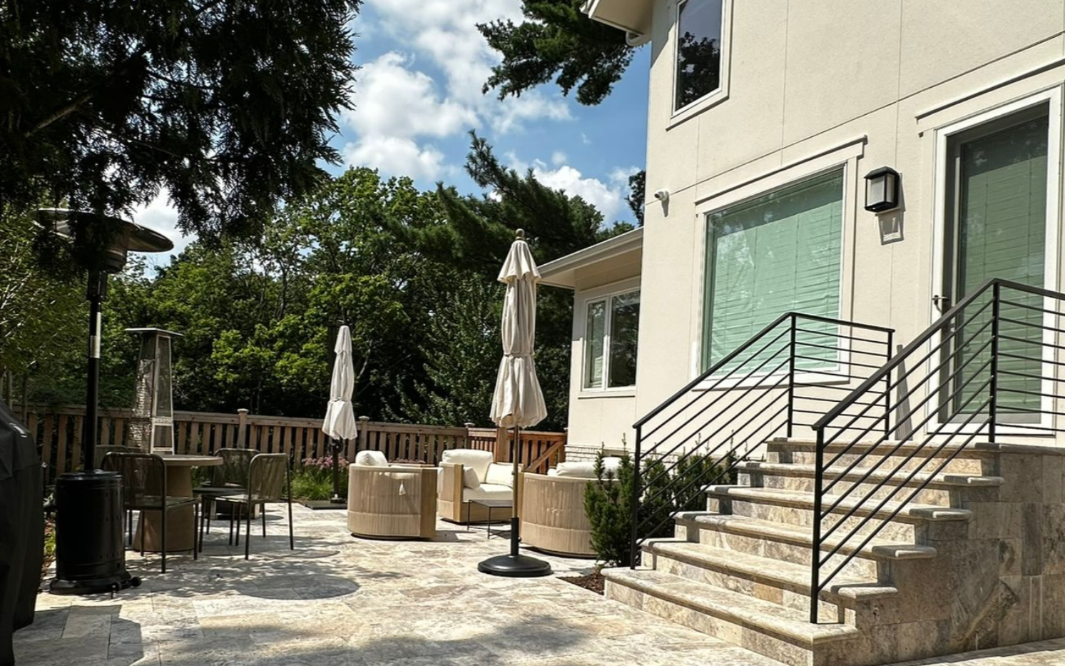 New white gray limestone mortared retaining wall with large 6 foot wide steps leading to curved front entry walkway on a hill in St. Louis Park MN project by KG Landscape 