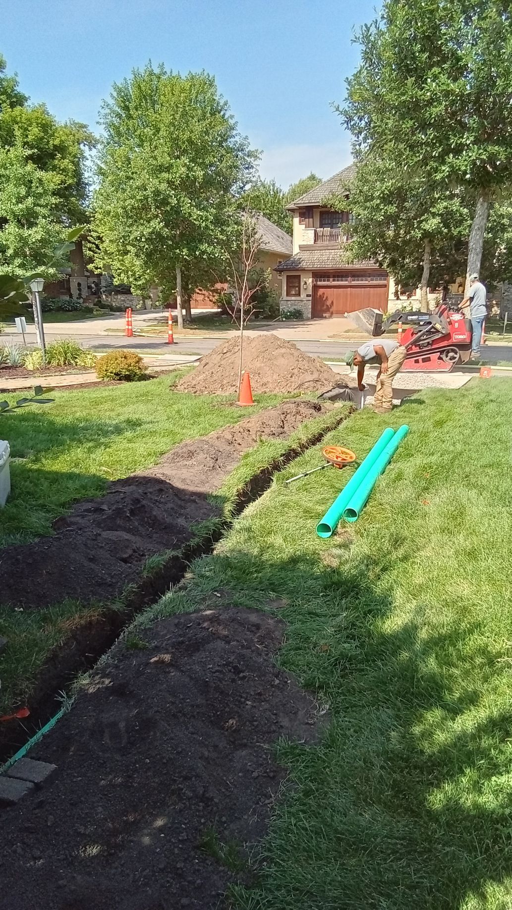 During: crew trenching drain pipe from sum pump discharge and excavating work for new dry well