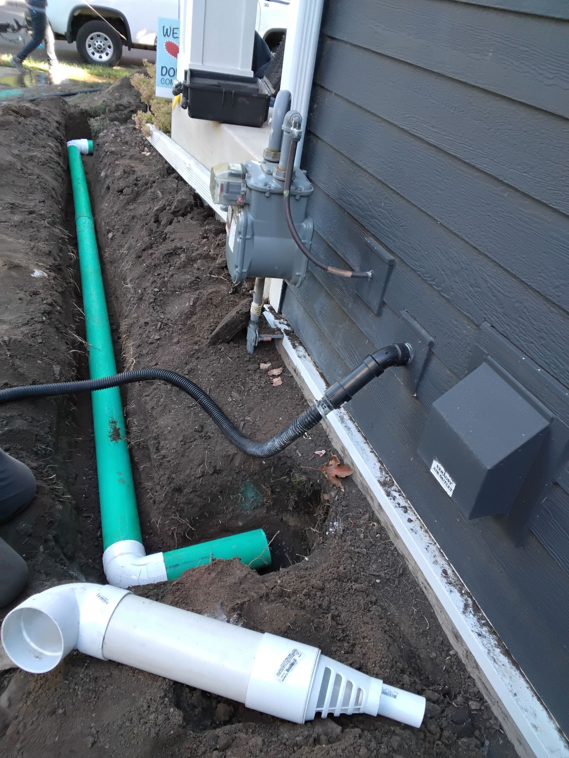 New underground sump pump drainage system in the landscaping being installed