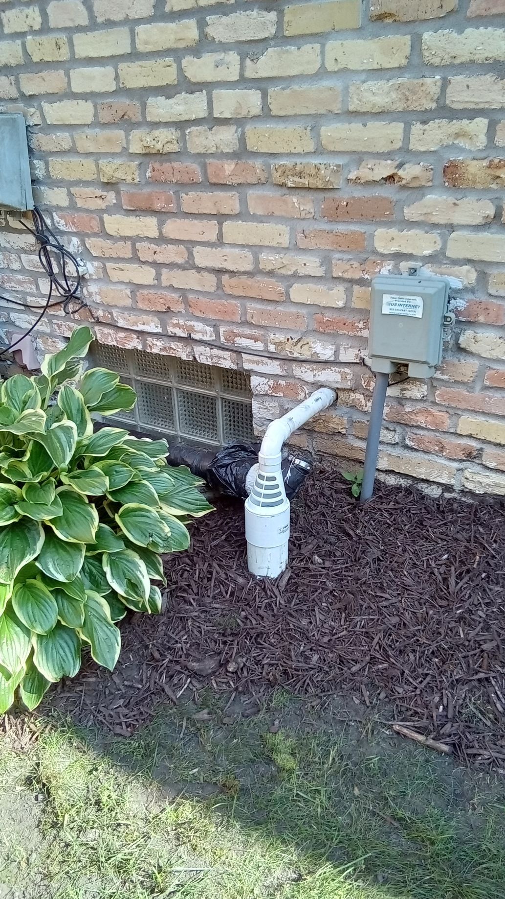 New sump pump discharge with air gap frost guard outside of house connected to underground drain pipe