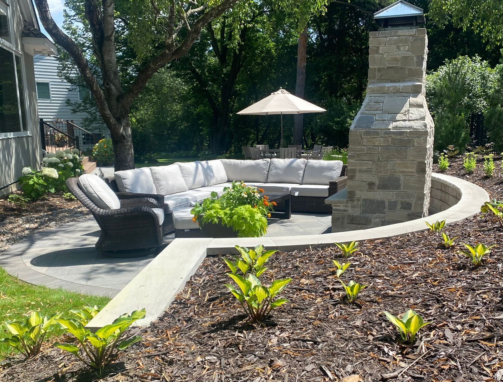 Outdoor+fireplace+backyard+natural+stone+with+chimney+on+patio+with+chairs+Minnetonka+MN+KG+Landscape