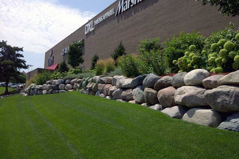 Well-maintained commercial landscape bed in Minnesota showing proper mulch depth and clean edges 