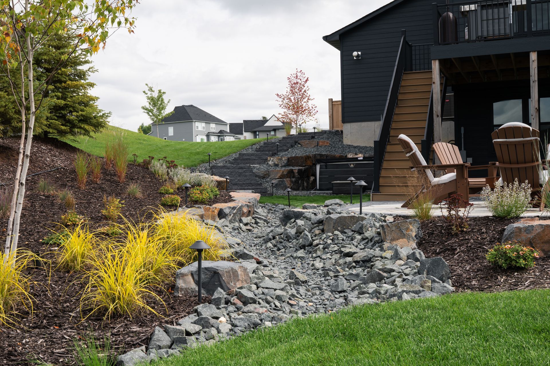 Dry creek bed surrounded by native plants and shrubs in Minnesota. 