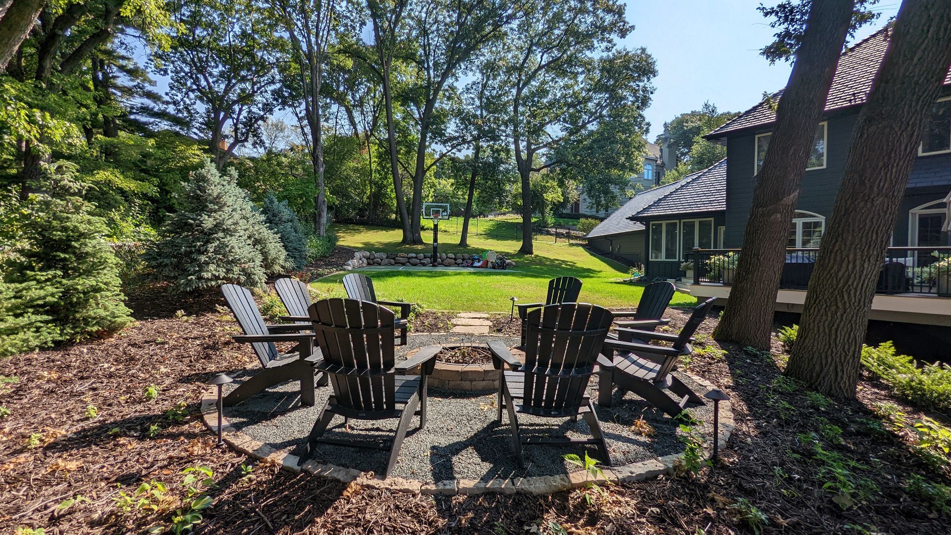 hillside+Backyard+gravel+fire+pit+area+adirondack+chairs+level+lawn+space+boudler+retainging+wall+sport+court+Edina+MN+KG+Landscape