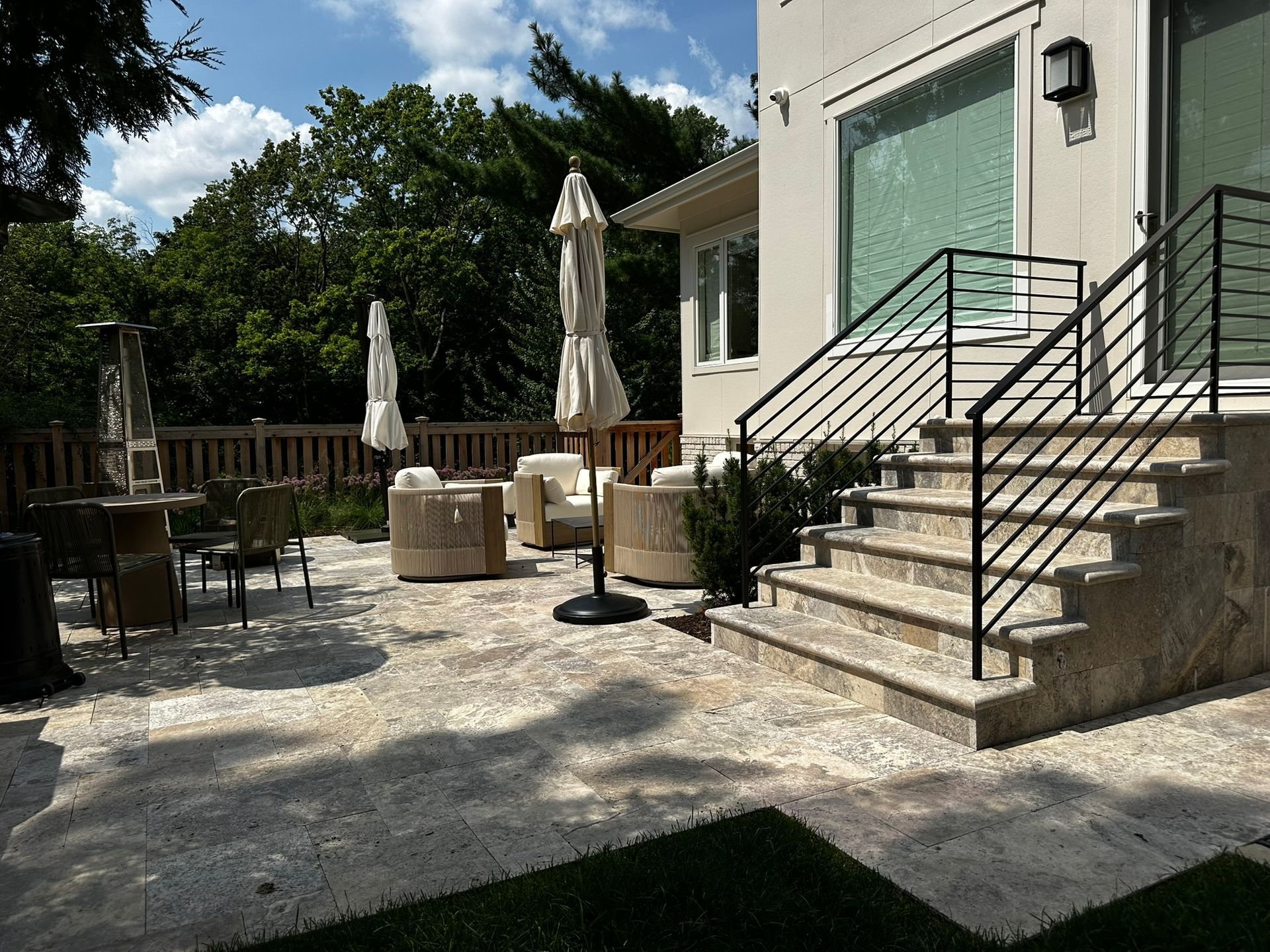 beautiful stoop and landing with natural stone and modern railing leading down to perfect patio in a Minneapolis small backyard 