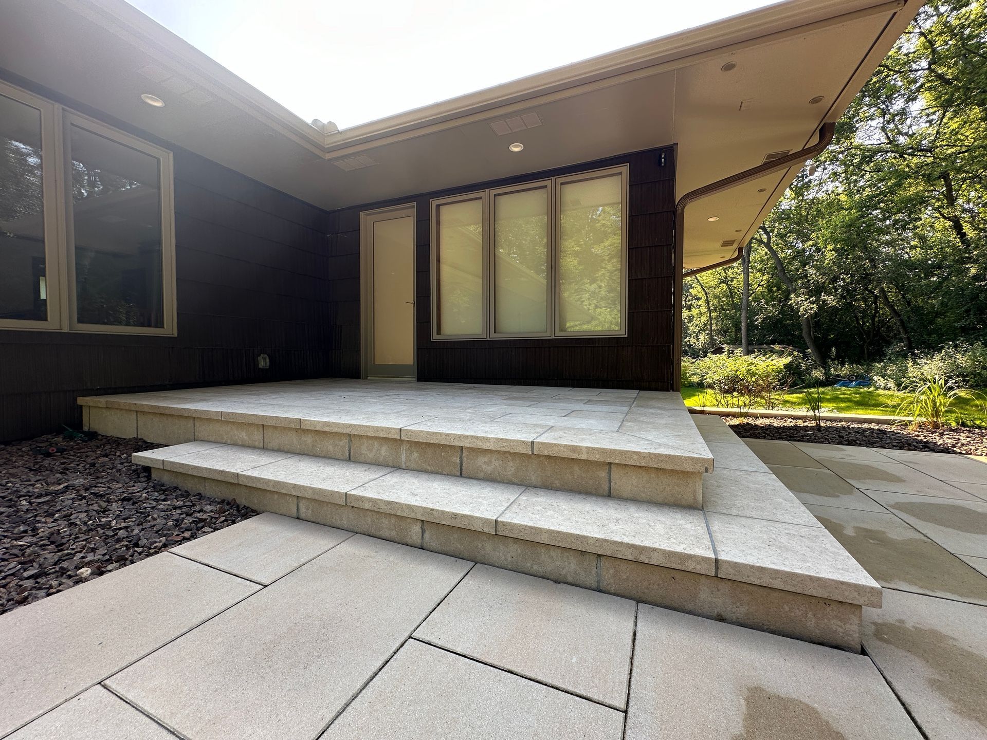 Pavers+covering+concrete Stone+faced+steps+stoop+landing+onto+paver+patio+from+back+door+mid+century+style+Hopkins+MN+KG+Landscape