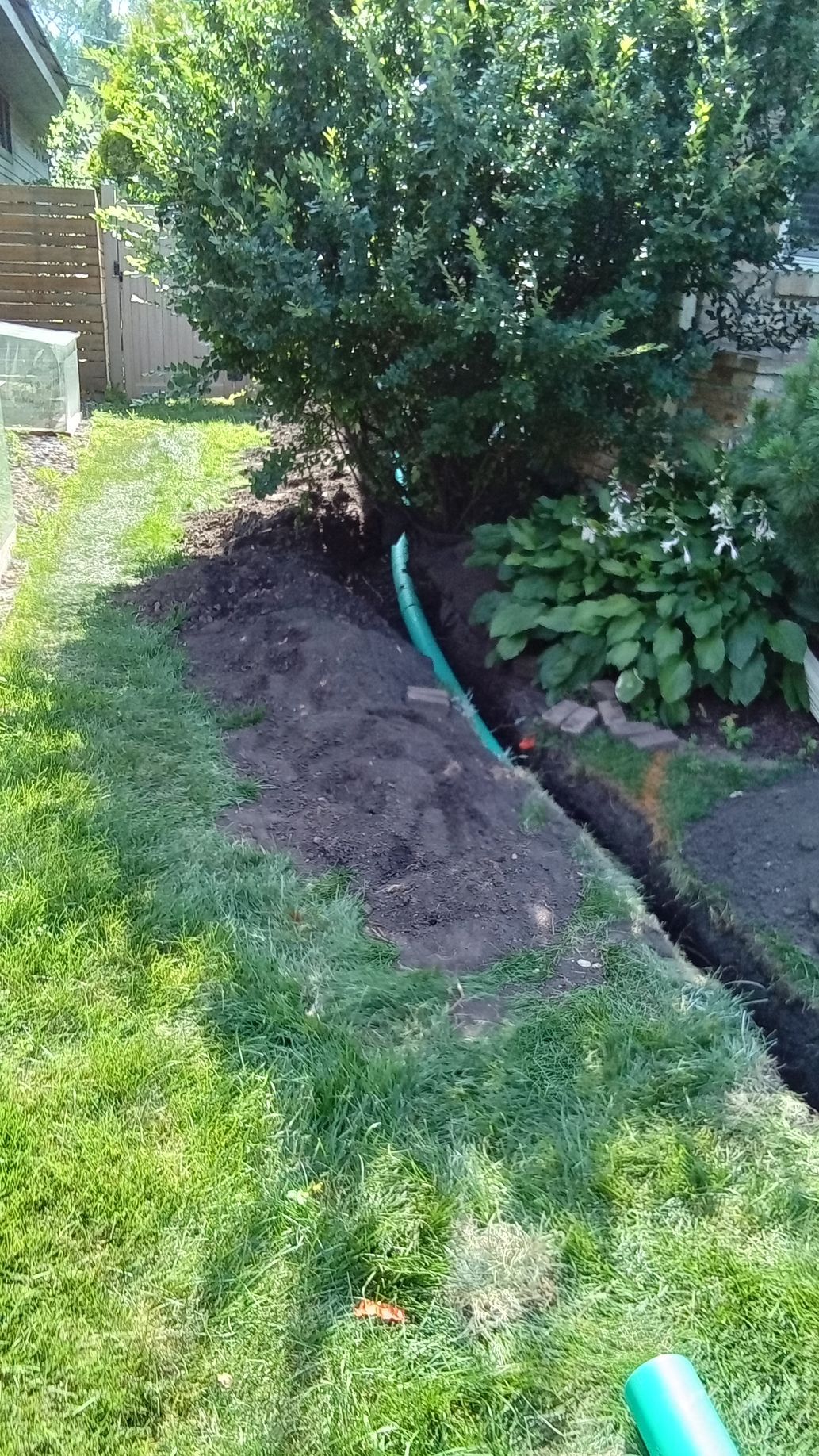 During: installing non-perforated PVC drain pipe from sump pump discharge running toward new dry well