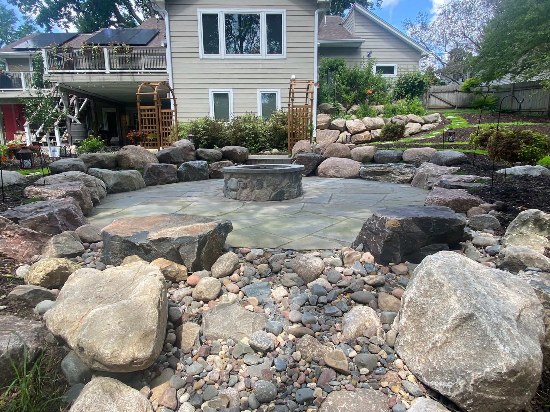 Sunken+Fire+Pit+Bluestone+patio+boulder+sitting+wall+custom+stone+fire+ring+dry+creek+bed+Plymouth+MN+KGLandscape.com