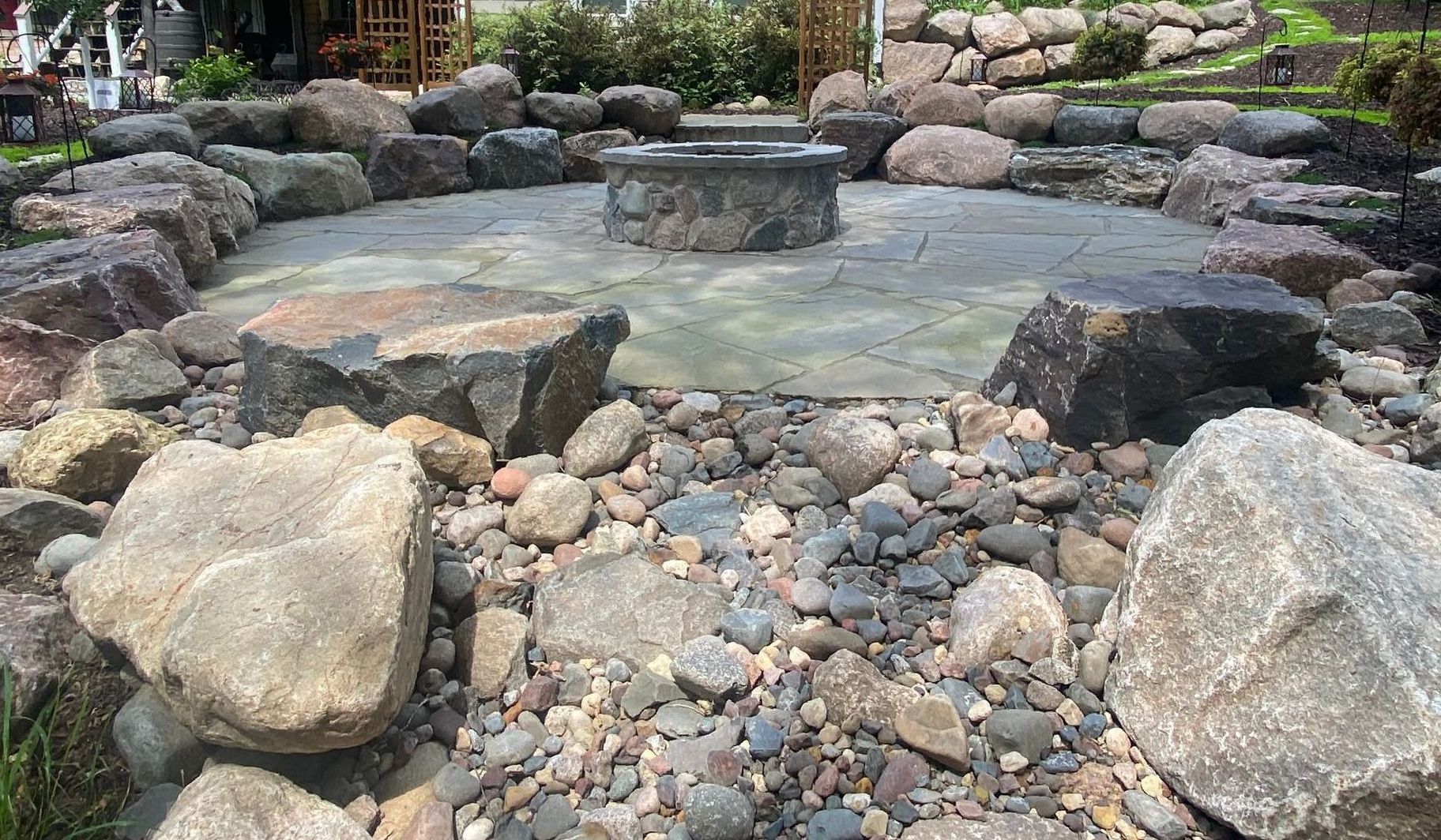 Sunken-Fire-Pit-Bluestone-patio-boulder-sitting-wall-custom-stone-fire-ring-dry-creek-bed-Plymouth-MN-KGLandscape.com
