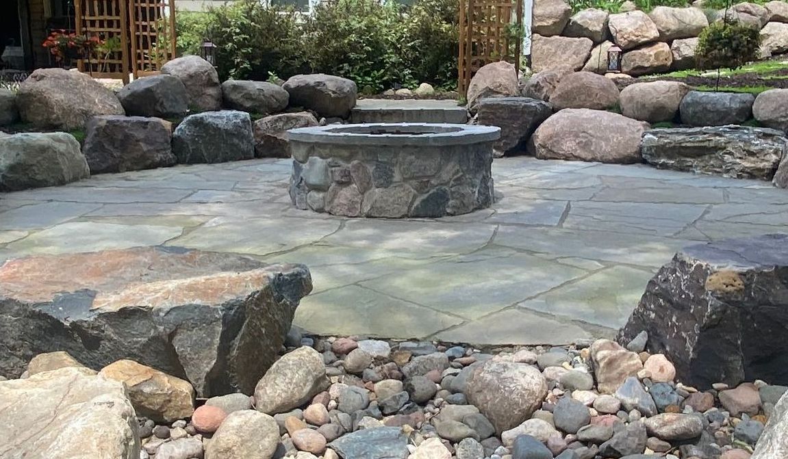 Sunken-Fire-Pit-Bluestone-patio-boulder-sitting-wall-custom-stone-fire-ring-dry-creek-bed-Plymouth-MN-KGLandscape.com