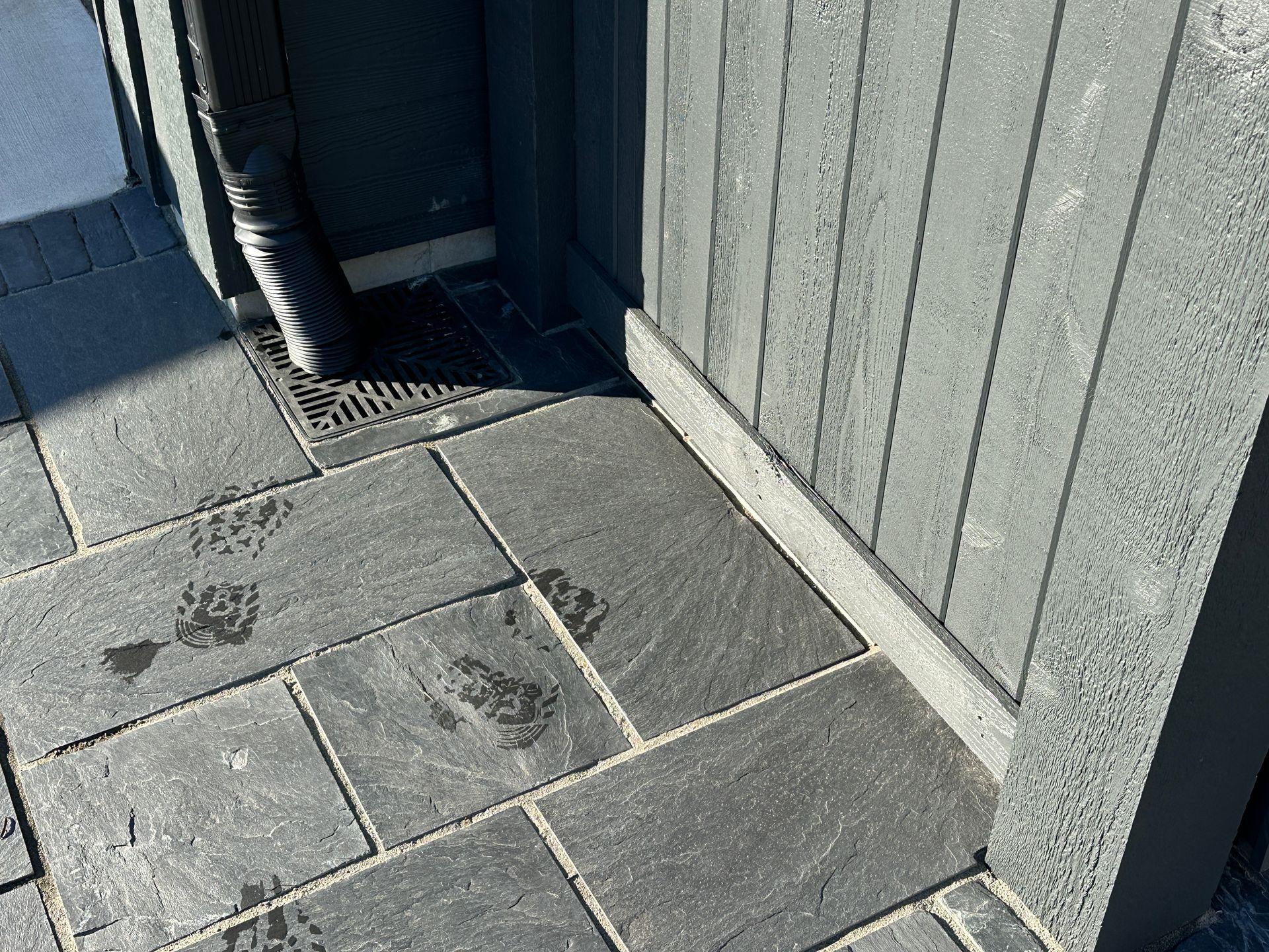 Underground downspout drain built into front walkway.