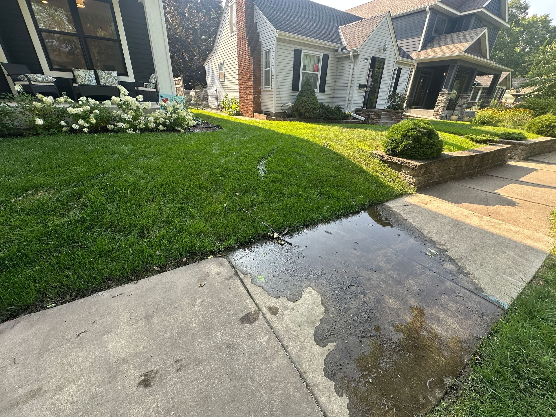 Water from sump pump line puddling on city sidewalk in front yard
