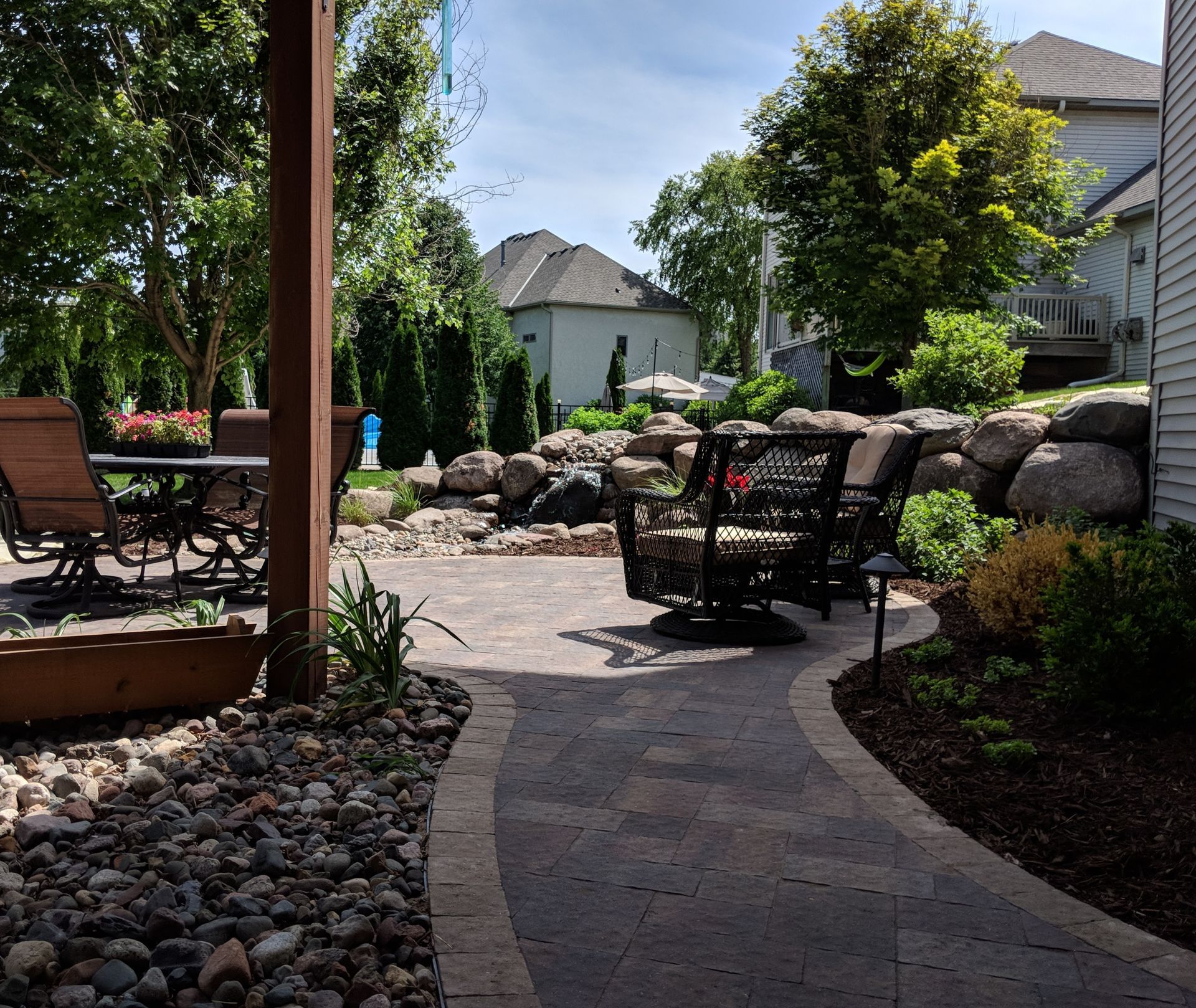 Backyard+Patio+pavers+below+deck+pathway+pondless+waterfall+feature+boudlers+KG+Landscape