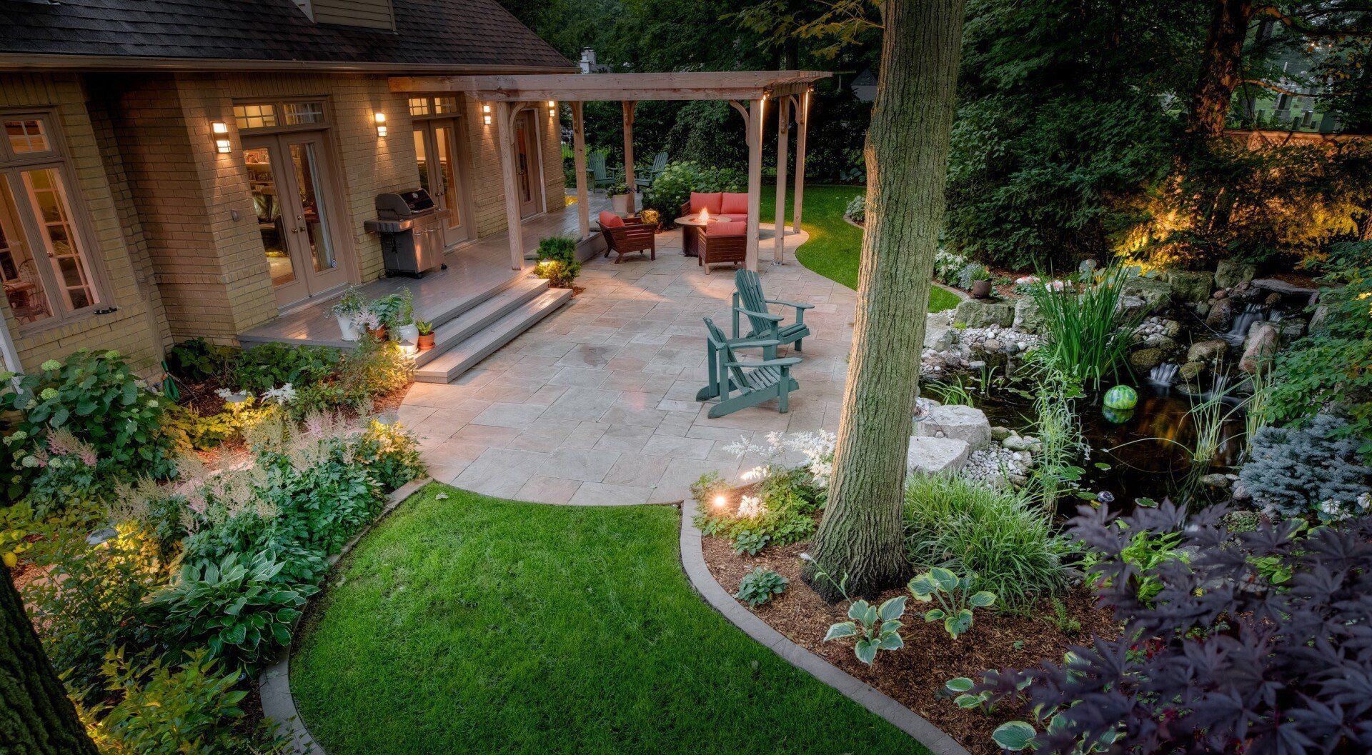 An aerial view of a backyard with a patio and a house in the background.