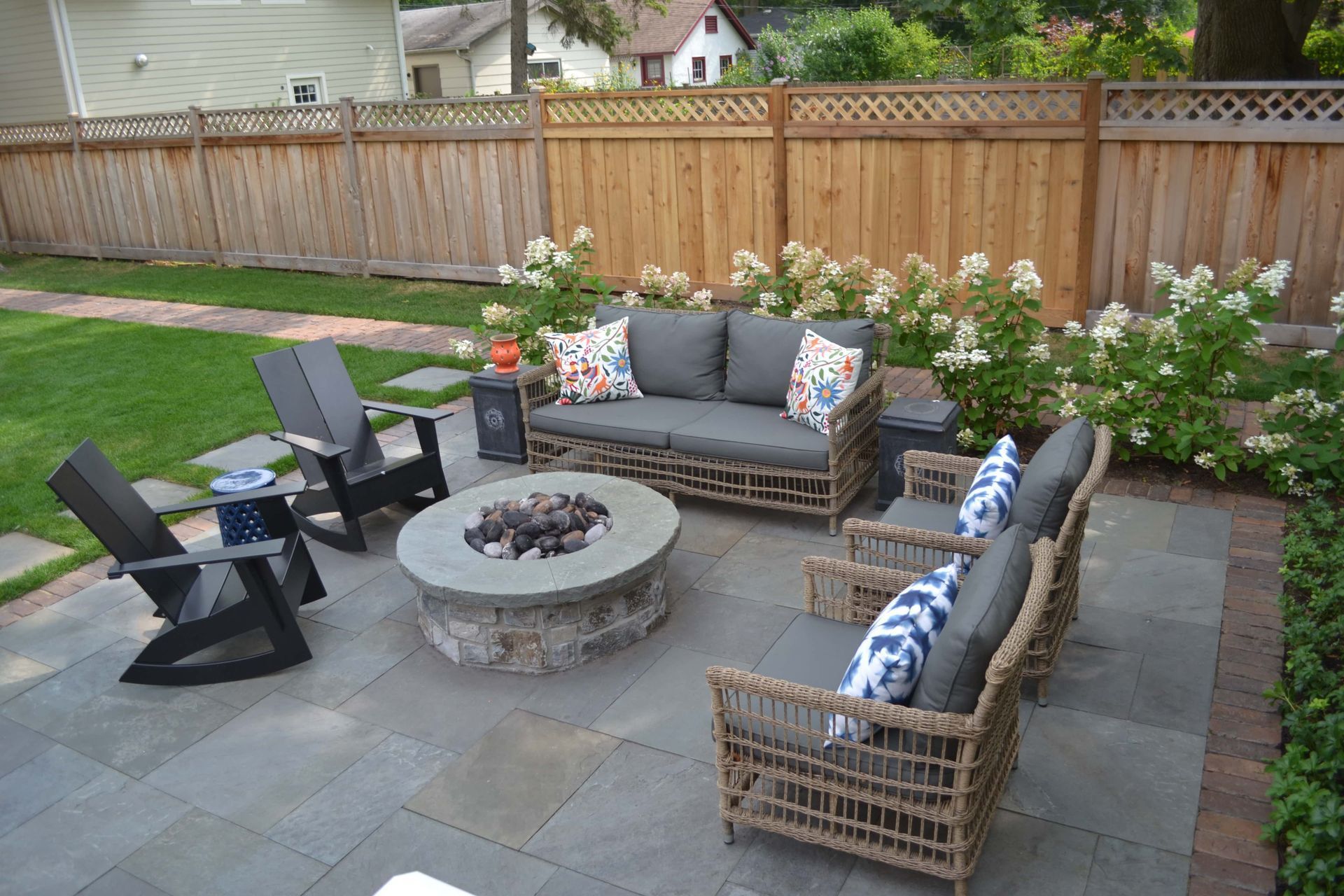 There is a fire pit in the middle of the patio.
