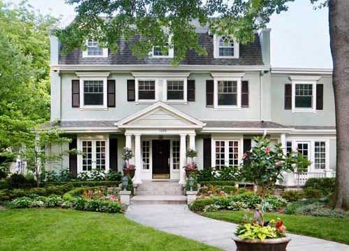 Beautiful luxury landscaping for traditional style classic older cape code style home symmetrical with flowers boxwoods colorful KG Landscape Edina MN 