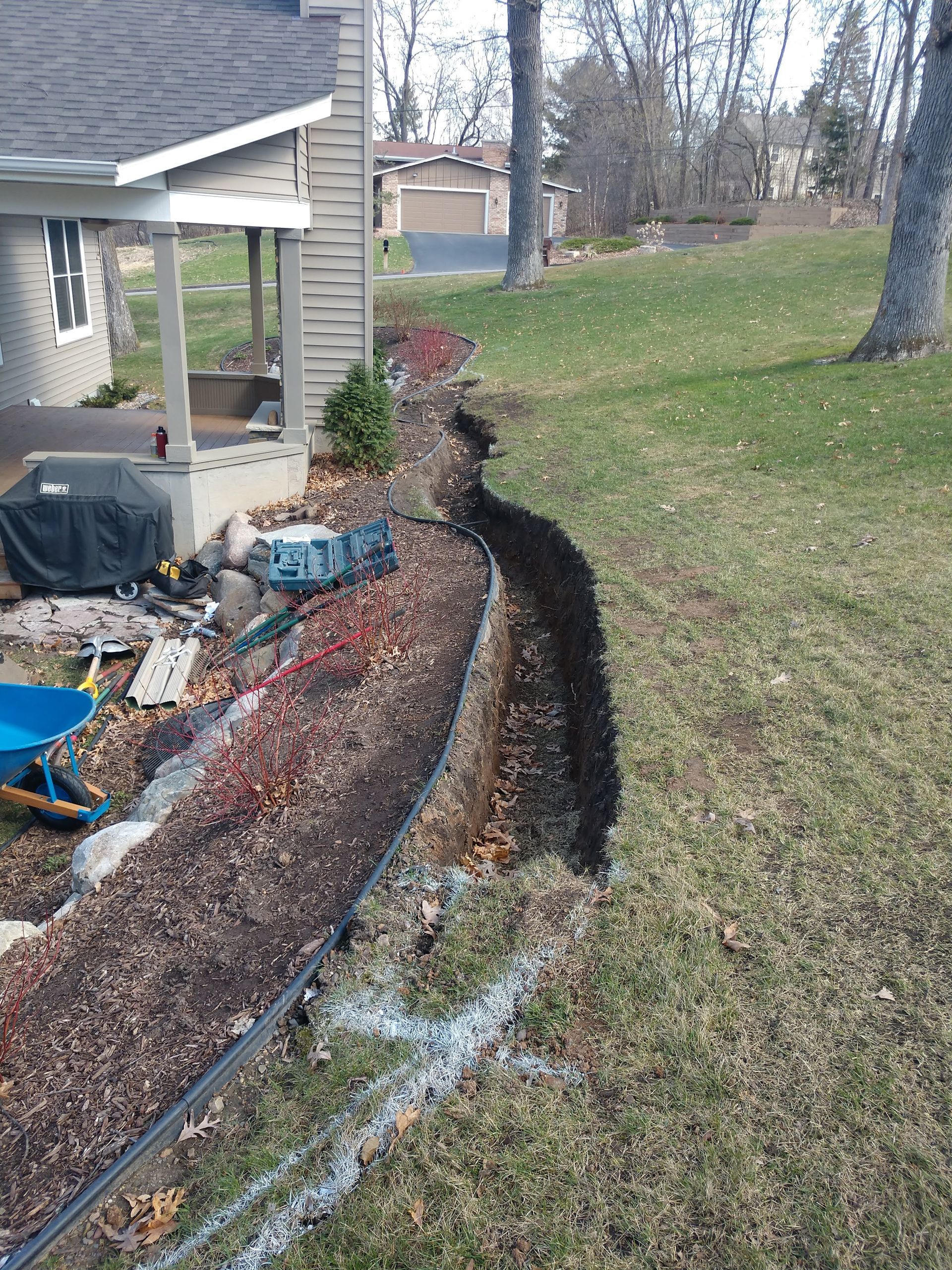 Our crew starting to excavate a large trench on the hillside where a new French drain will collect water rushing down the hill