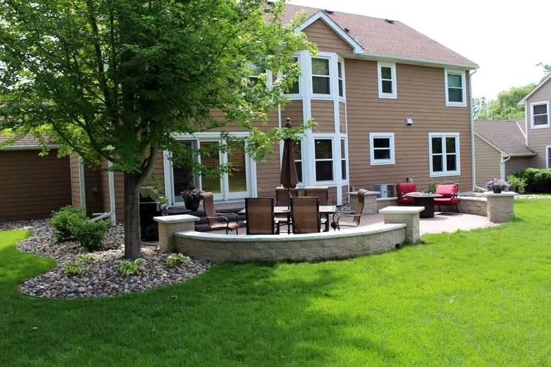 Well Designed backyard patio with sitting wall and stone columns KG Landscape Eden Prairie MN 