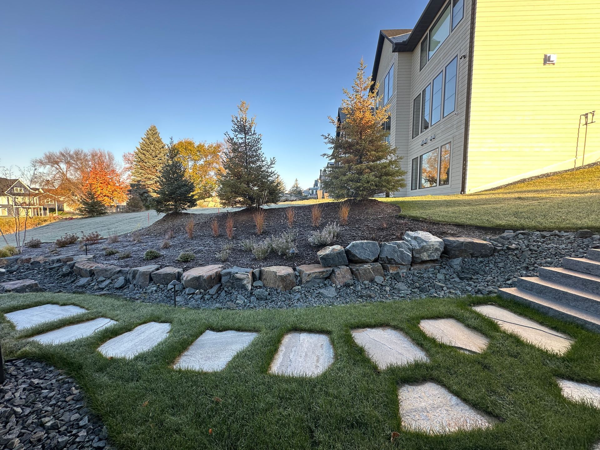 flagstone path built into lawn in sloped sideyard stone steps
