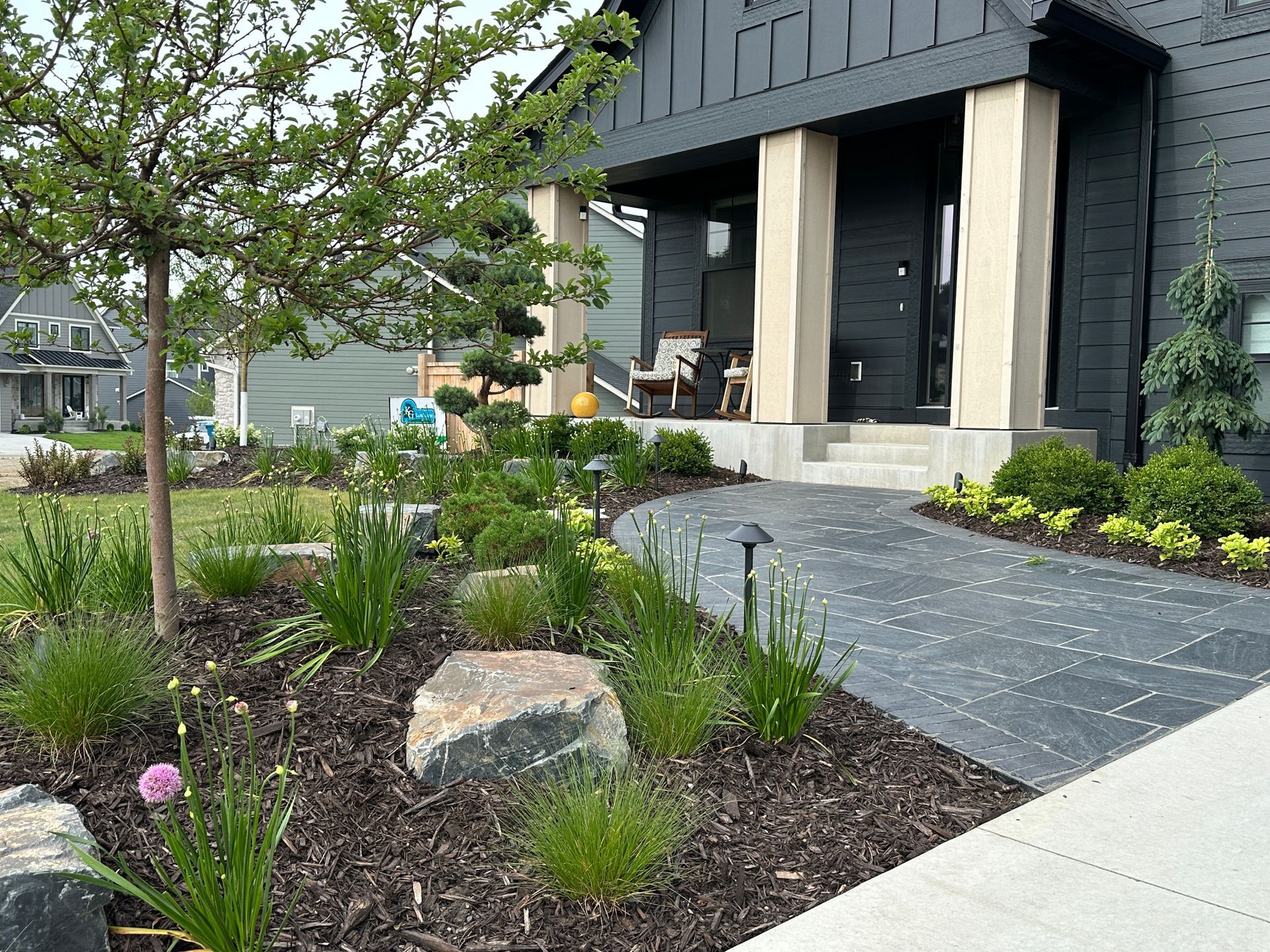 front yard with plants trees and front porch