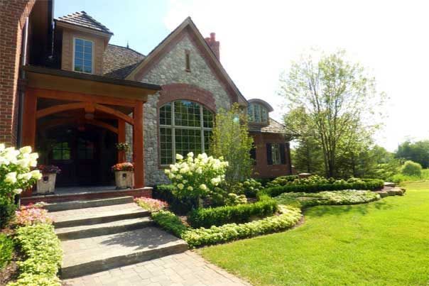 A large house with a lush green lawn in front of it