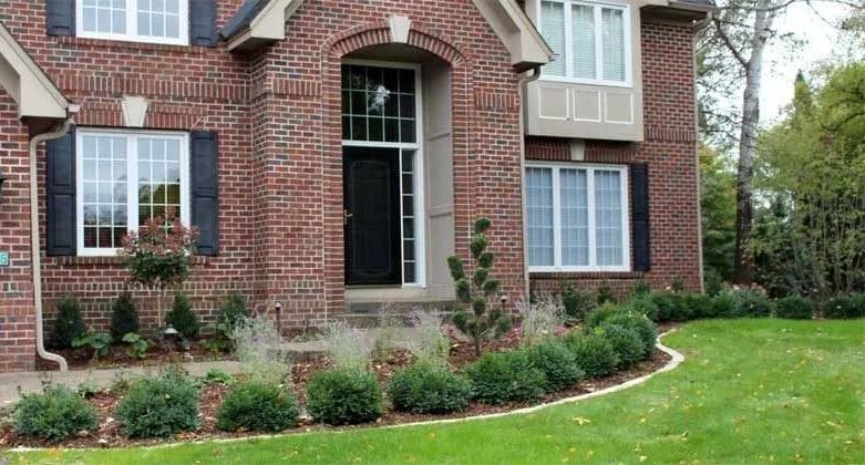 New front yard landscaping idea with boxwoods and a topiary evergreen focal point design and installed by KGLandscape.com in Eden Prairie Minnesota 