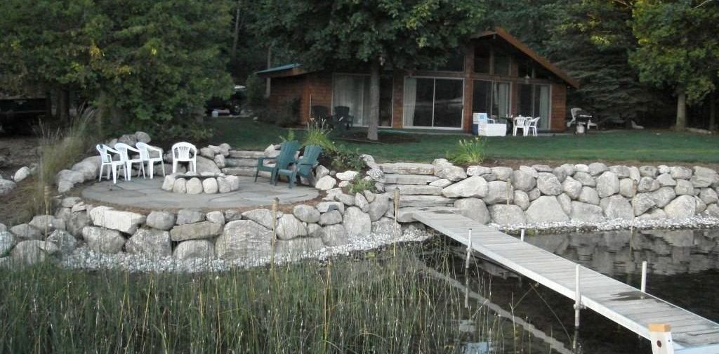 A house with a dock and chairs in front of it