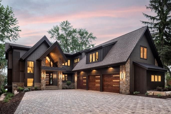 A large house with a brick driveway in front of it