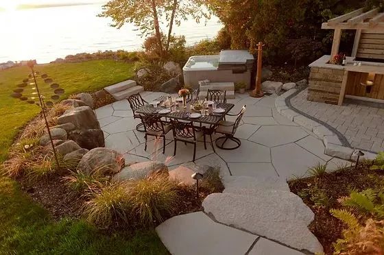 Irregular flagstone patio with sitting area on a lake in MN 