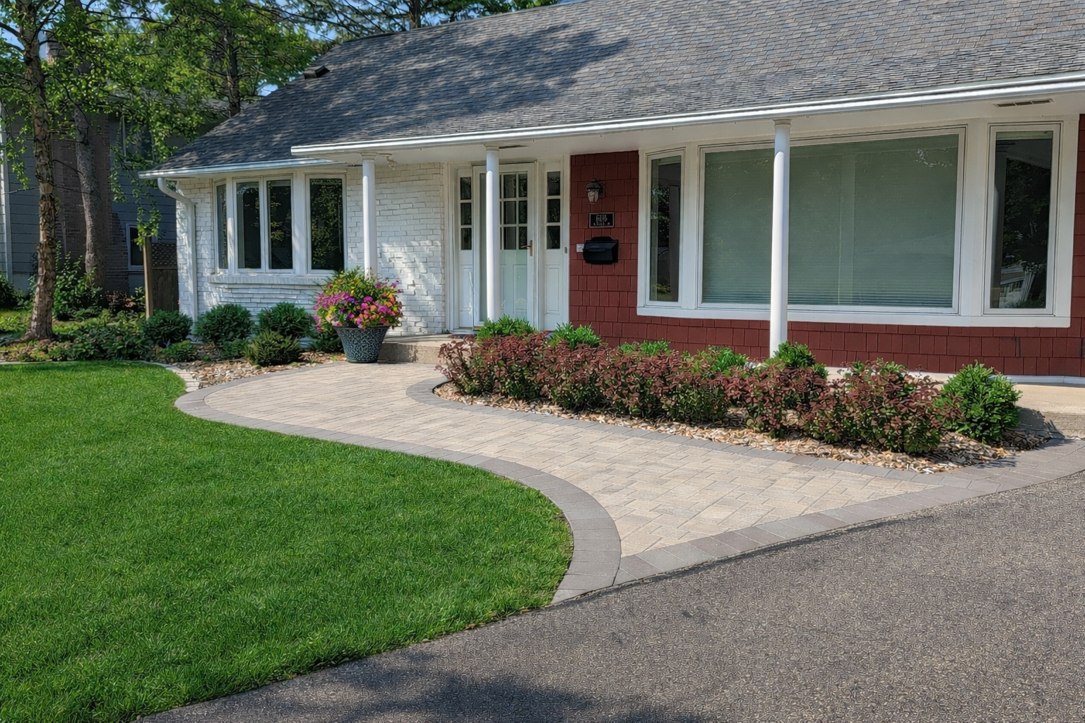 new front yard landscaping renovation project we did in Edina MN with new paver walkway, boxwoods and flowers — simple and clean cut