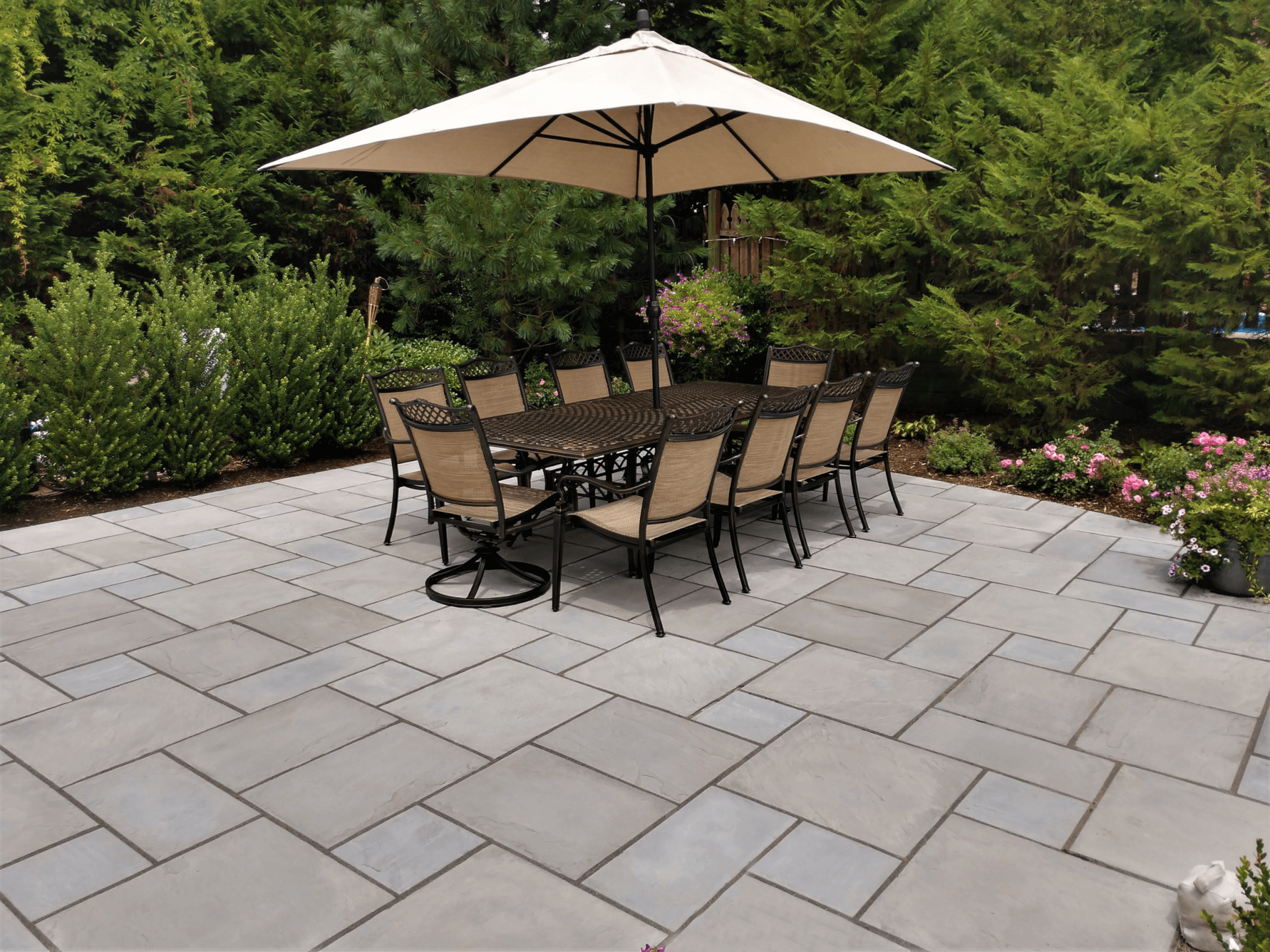 A patio with a table and chairs and an umbrella