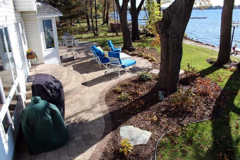 Curved shape paver patio with rounded half circle steps designed by KG Landscape Forest Lake MN 
