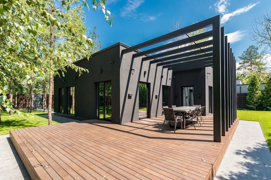 A modern house with a wooden deck and a pergola.