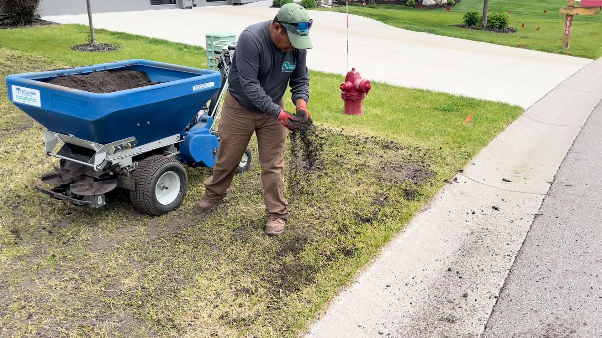 Spreading organic compost on Twin Cities lawn. 