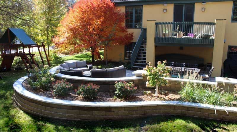 A large house with a patio and a playground in the backyard.