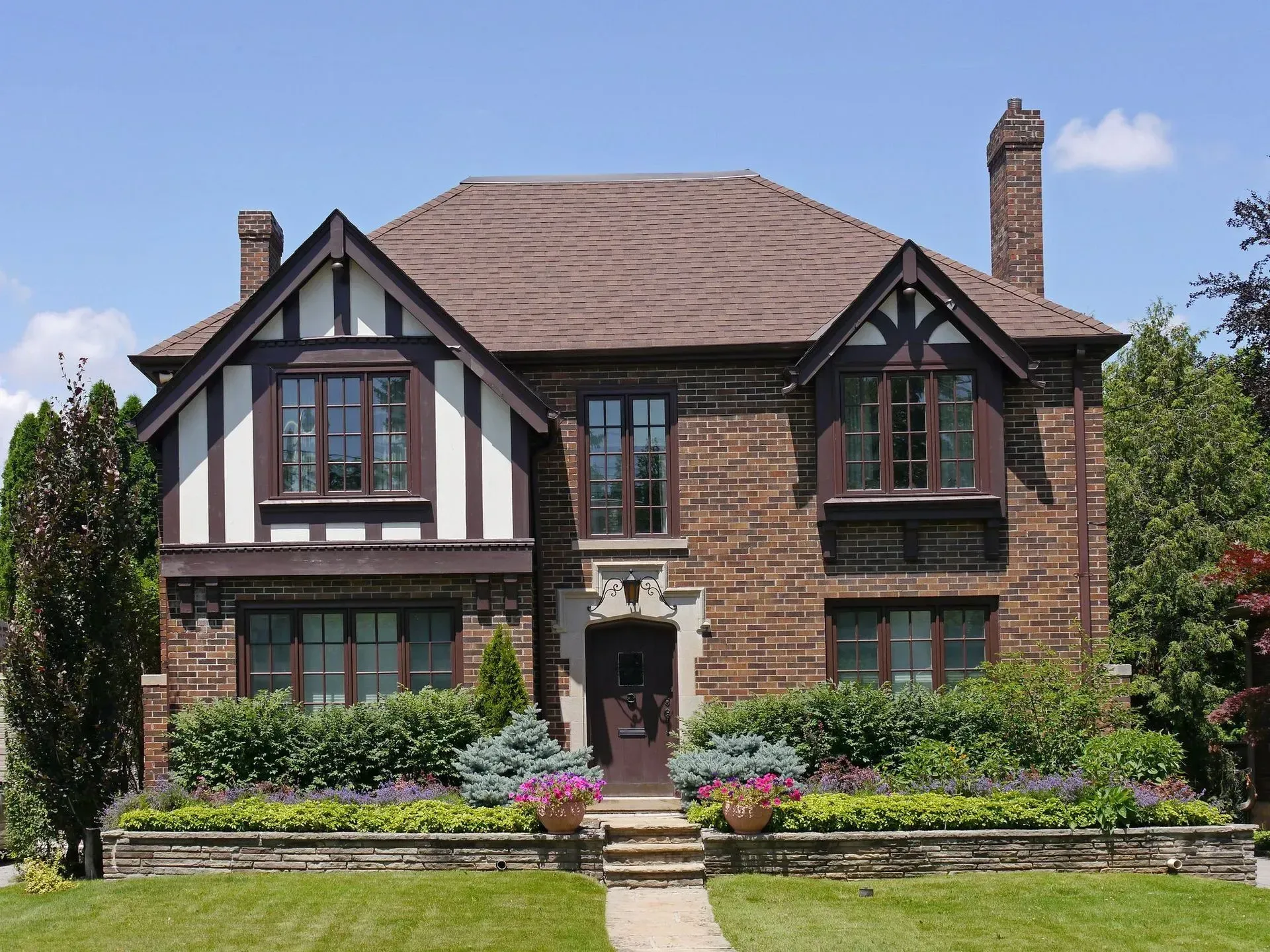 A large brick house with many windows and a chimney