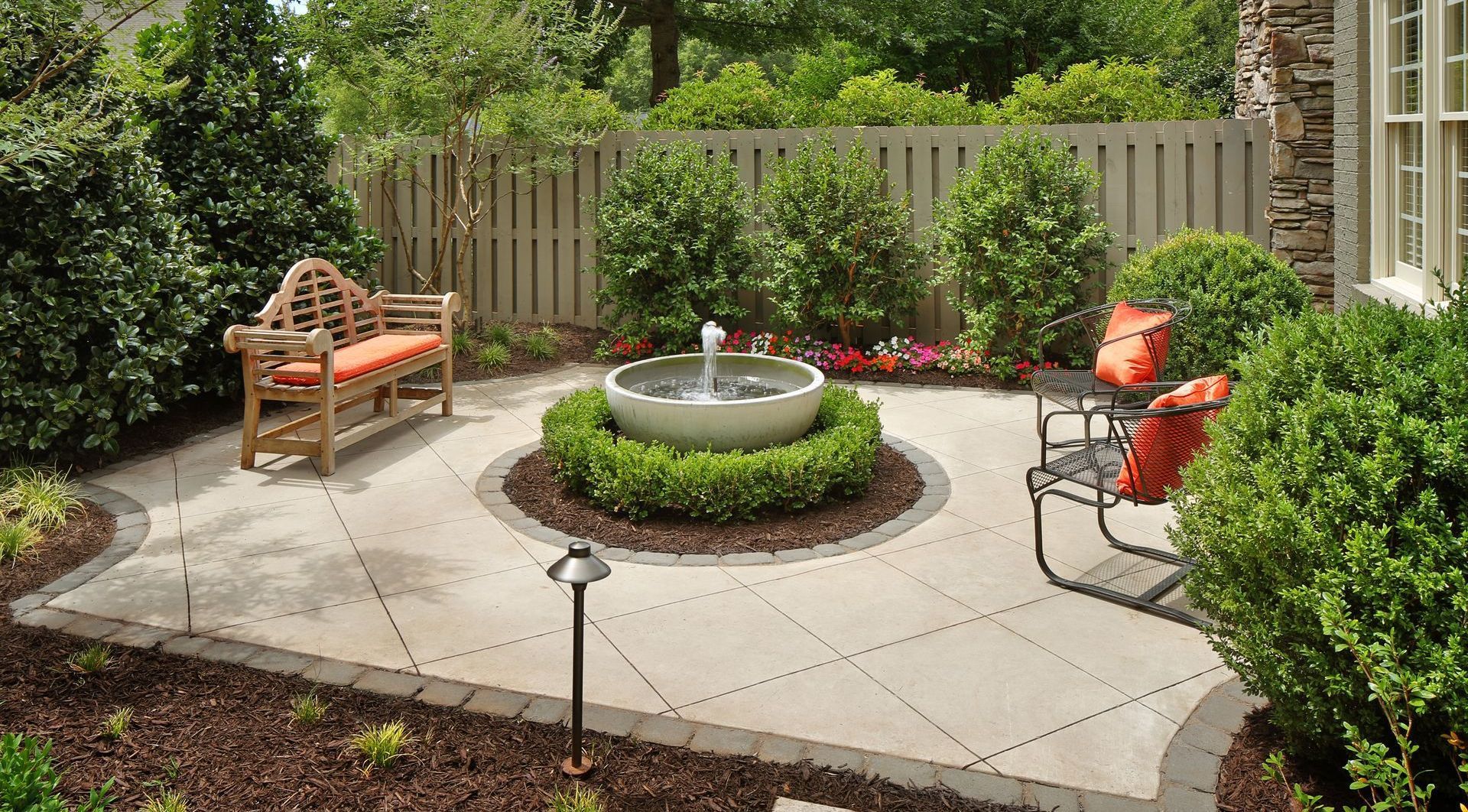 There is a fountain in the middle of the patio.